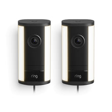Two black Ring Spotlight Cam 4K Pro plug-in cameras with vertical light strips, front lenses centered, shown side by side on a white background.