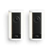 Two white-and-black Ring Spotlight Cam 4K Pro plug-in cameras with front lenses and light strips, shown side by side on a white background.
