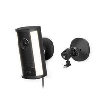 Black wall-mounted Spotlight Cam 4K Pro with vertical light panels, lens centered, power cable attached, shown with separate mounting bracket.