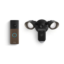 Ring doorbell with blue-lit button next to a black floodlight camera with dual adjustable lights on a white background.