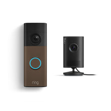 Ring doorbell with bronze faceplate and glowing blue button beside a compact black indoor camera on a stand, both against a white background.