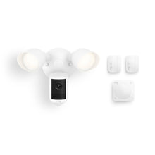 White Ring floodlight camera with two lit lamps, shown with two contact sensors and a square motion detector on a white background.
