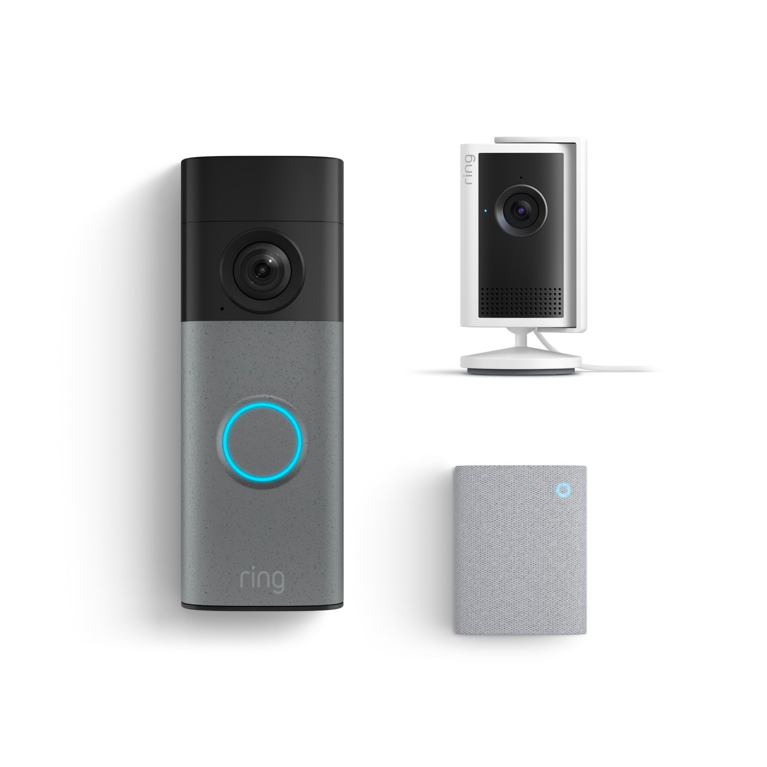 Ring doorbell with glowing blue button, a compact indoor camera on a stand, and a small gray chime speaker on white background.