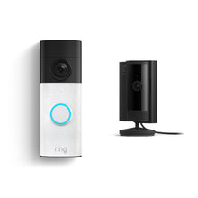 Ring video doorbell with glowing blue button on left, and a small black indoor camera on a stand with power cable on right.