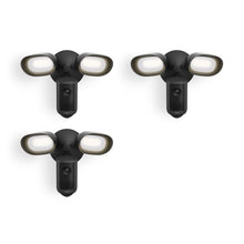 Three black outdoor floodlight fixtures with built-in cameras, each with two bright oval LED lights on a white background.