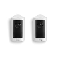 Two white Ring indoor security cameras side by side on a white background, each with a black lens panel and speaker grille.