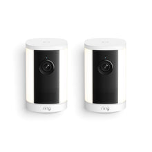 Two white cylindrical Ring spotlight cameras with black lens panels and LED light strips, shown side by side on a white background.