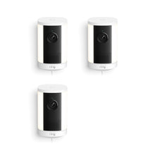 Set of three white Ring spotlight cameras with black fronts and lenses, arranged in a triangle on a white background.