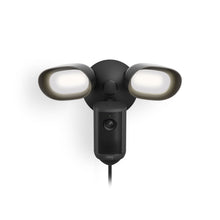 Black outdoor floodlight with two LED lamps and a central camera unit, wall-mounted against a white background.