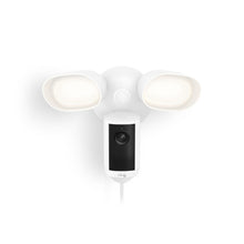 White Ring floodlight with built-in camera, two bright LED lamps angled outward, and a wired design against a plain background.