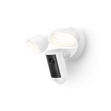 White wall-mounted security floodlight with integrated black-and-white camera unit, two adjustable LED lamps, minimal background.