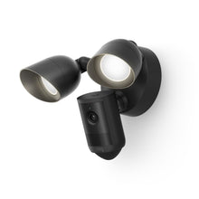 Black outdoor floodlight with dual adjustable LEDs and integrated camera mounted on a wall, shown at an angle on a white background.