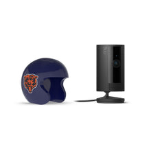 Black Ring Stick Up Cam next to a dark blue mini football helmet with an orange bear logo on a white background.