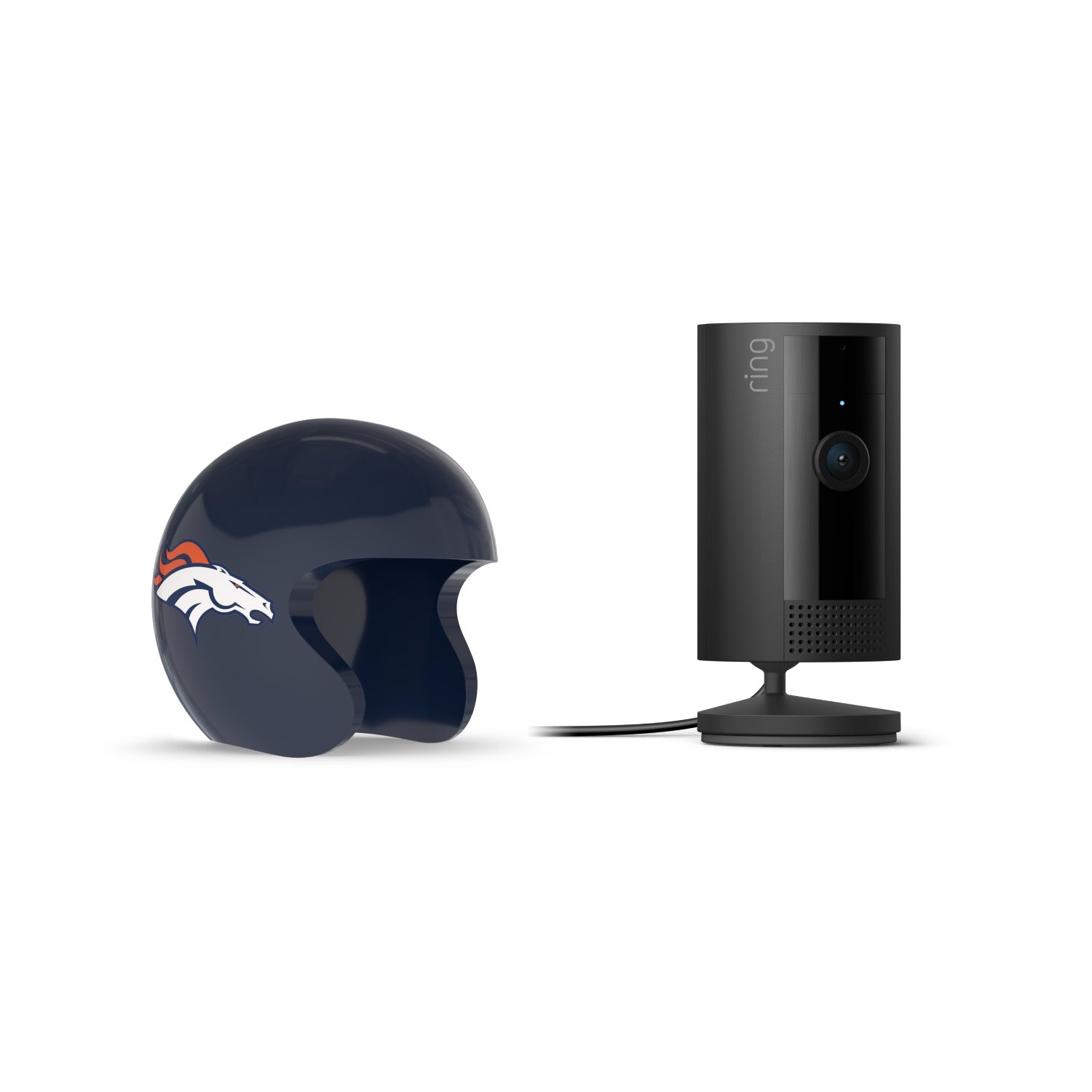 Black Ring indoor camera on a stand beside a navy football helmet with a white horse logo, set on a white background.