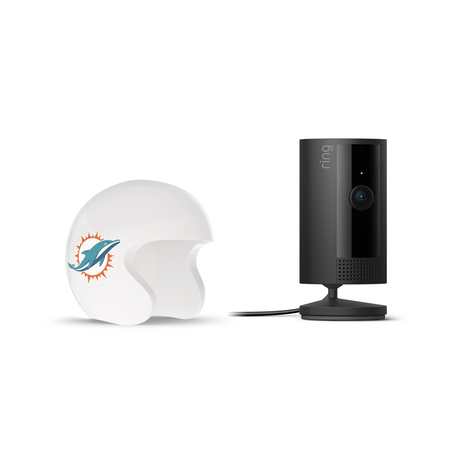 Black Ring indoor camera on a stand beside a white mini football helmet with a teal dolphin logo, on a white background.