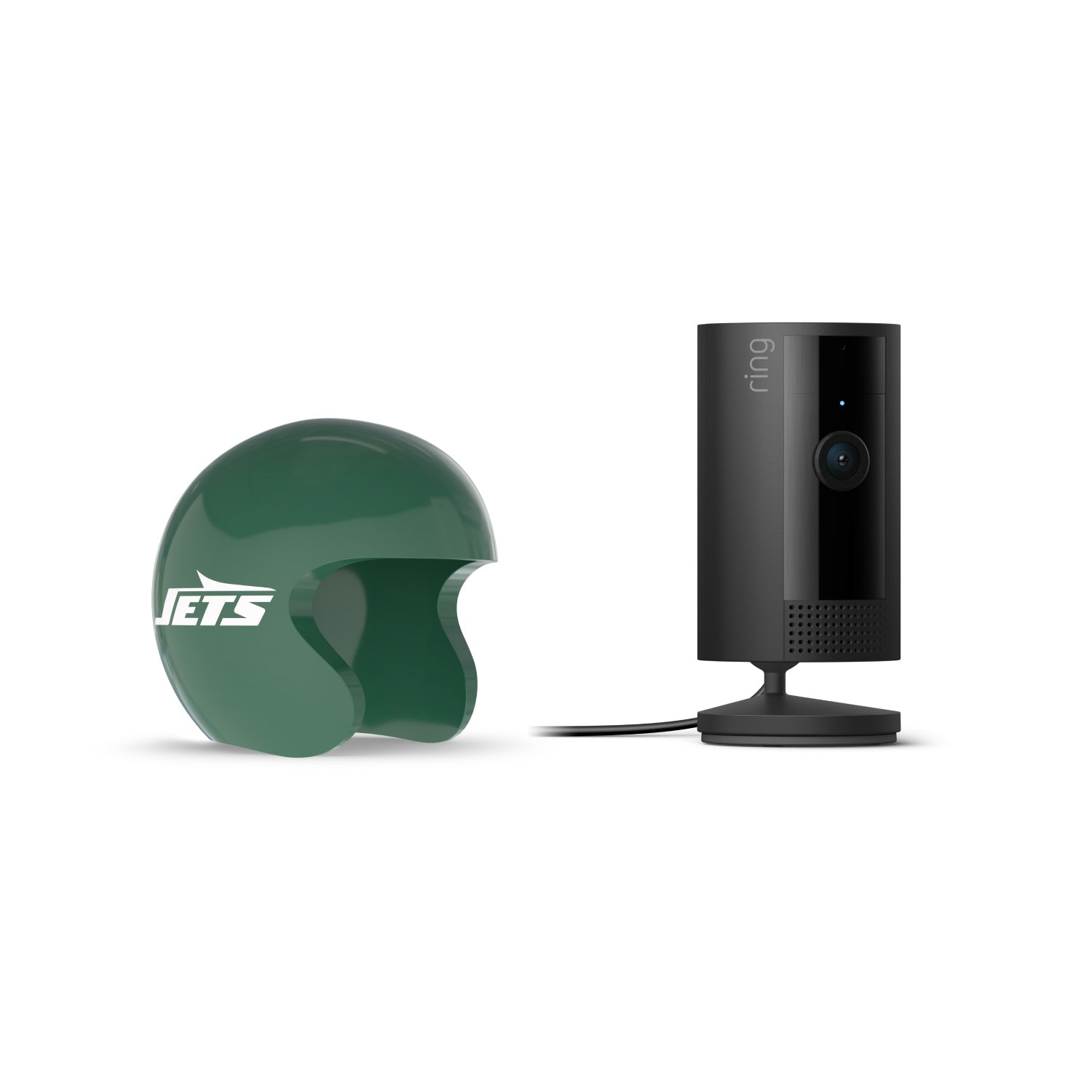 Black Ring indoor camera on a stand beside a green Jets mini helmet on a white background.