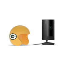Black Ring indoor camera next to a yellow Green Bay Packers mini helmet on a white background.