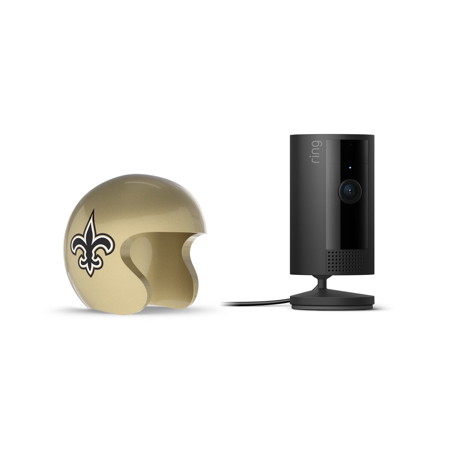 Black Ring indoor camera on a stand beside a gold mini football helmet with a fleur-de-lis logo on a white background.