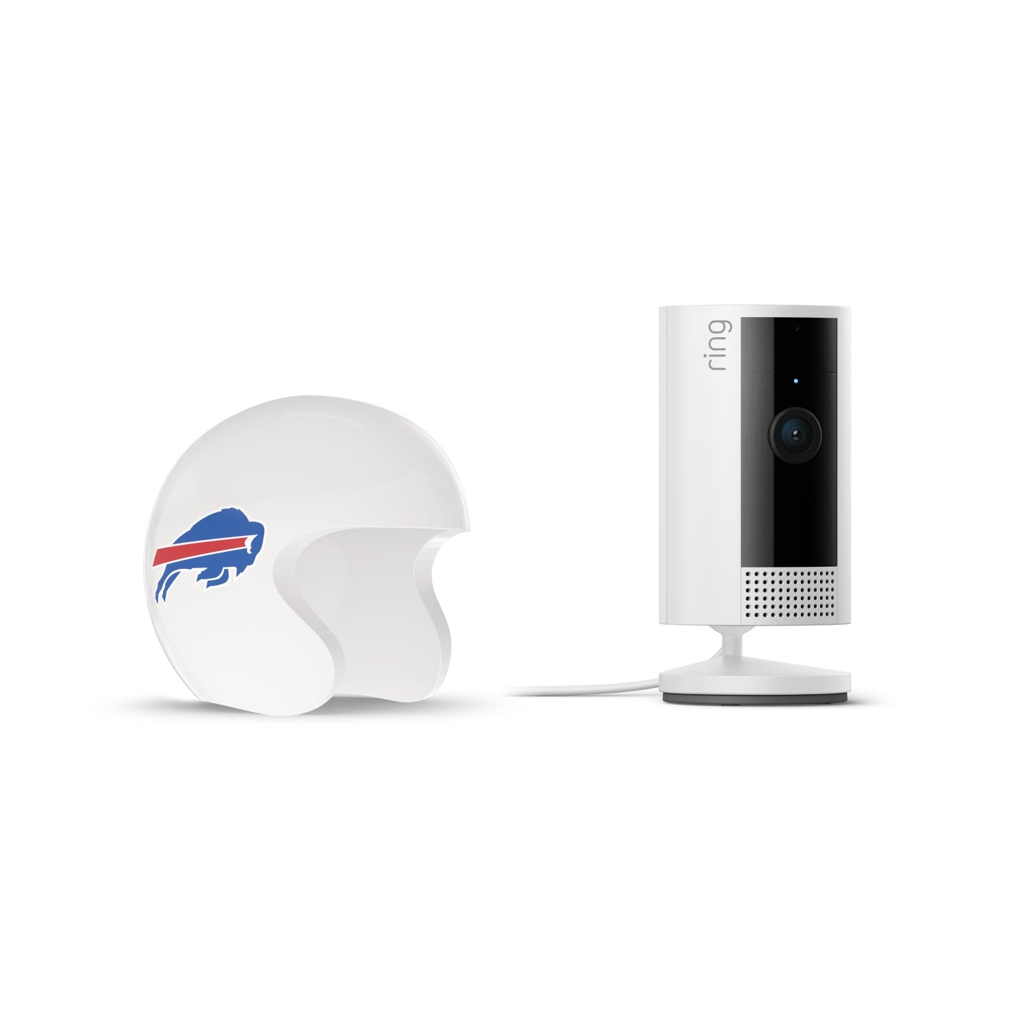 White Ring indoor camera on a stand next to a white mini football helmet with a blue buffalo and red stripe logo on a plain background.