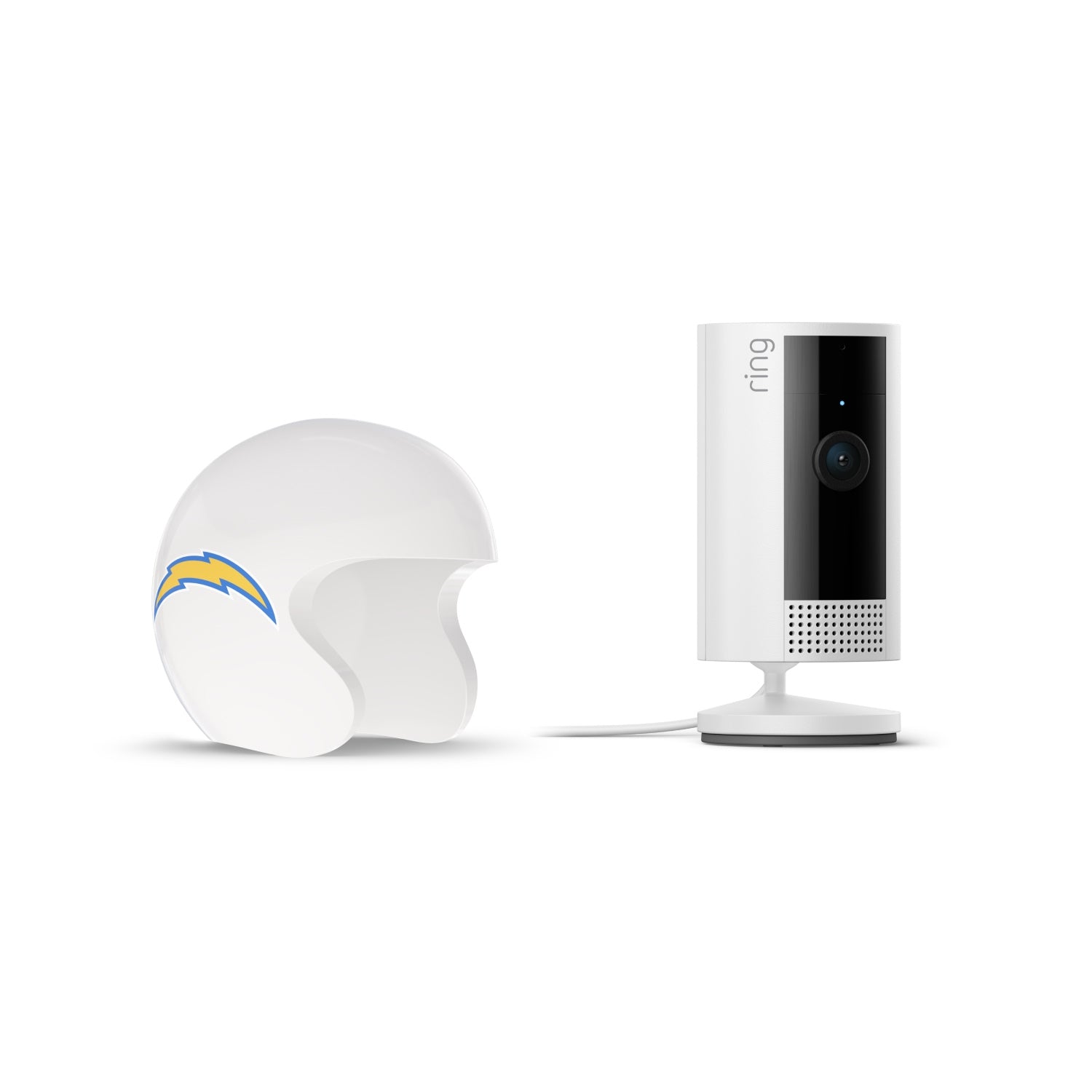 White Ring indoor camera on stand next to a white football helmet with a blue and yellow lightning bolt logo on a plain white background.