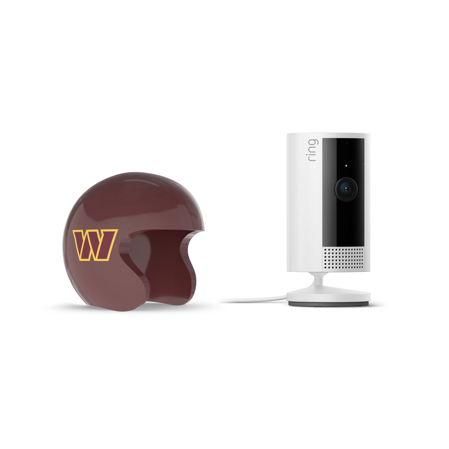 White Ring indoor camera on a stand next to a maroon football helmet with a yellow W logo, set against a white background.