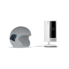 Ring indoor camera beside a gray mini football helmet with a black-and-blue panther logo on a white background.