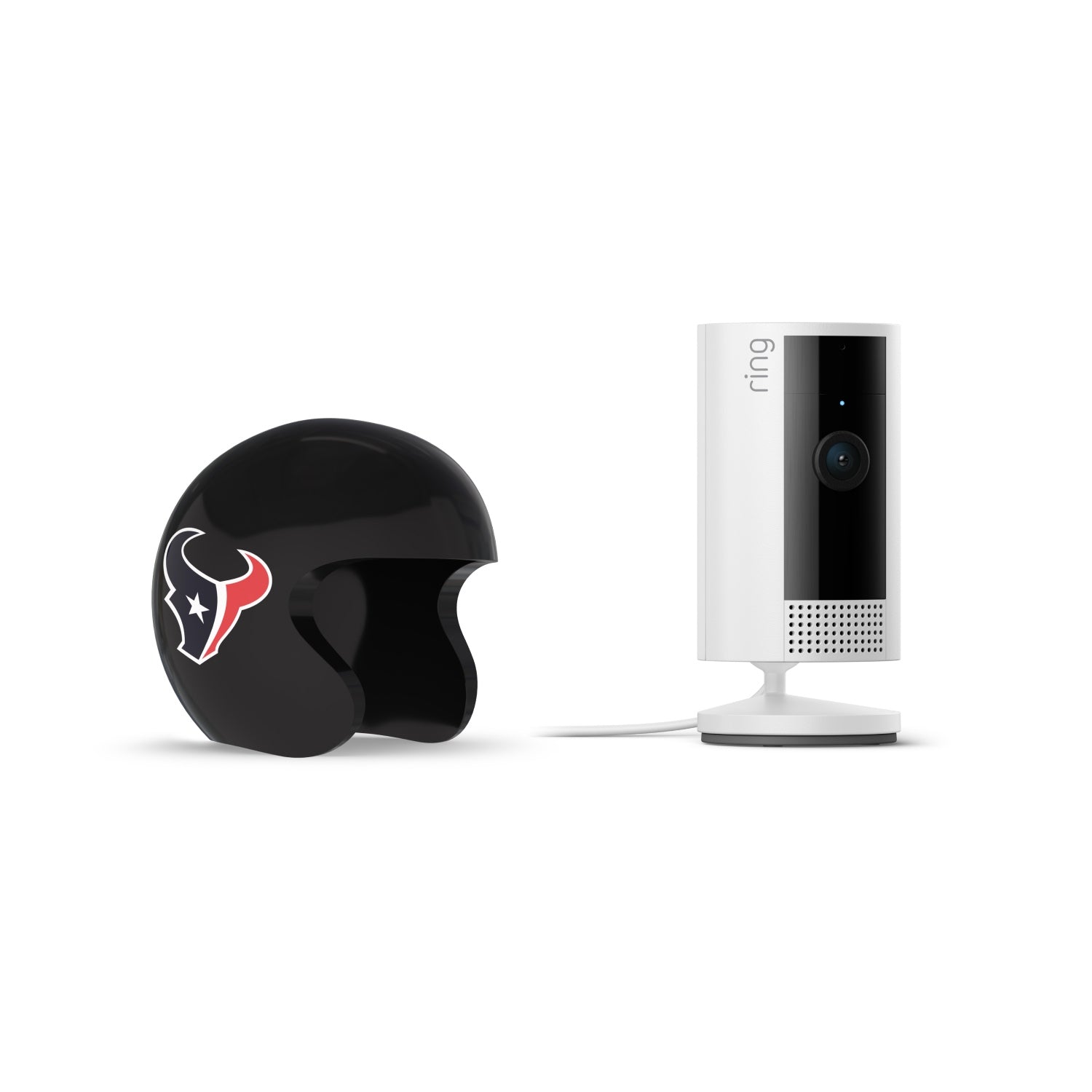 White Ring indoor camera on a stand next to a black sports helmet featuring a red, white, and blue bull logo on white background.