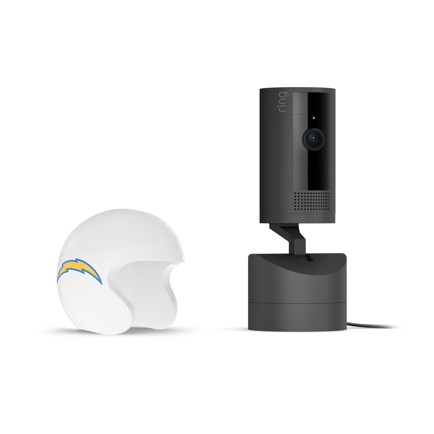 Black Ring indoor camera on a powered stand next to a white mini football helmet with a blue and yellow lightning bolt logo on white background