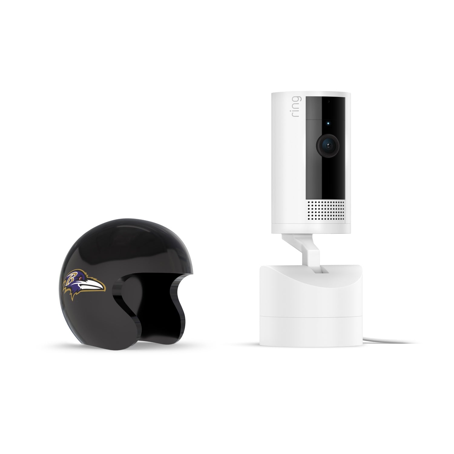 White Ring Pan-Tilt indoor camera on a stand next to a glossy black mini football helmet with a purple raven logo on white background
