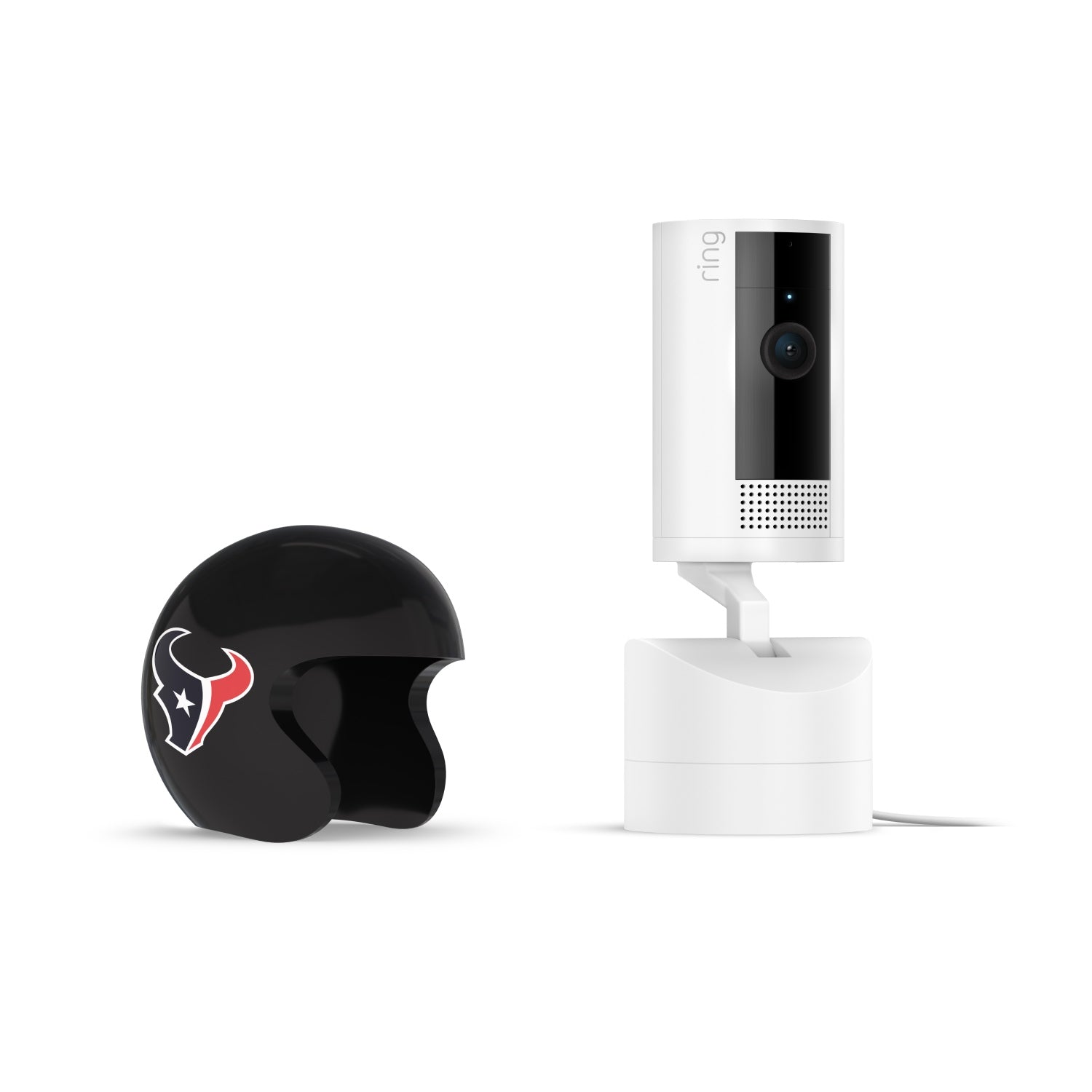Black mini football helmet with Houston Texans logo beside a white Ring Pan-Tilt indoor camera on a stand against a plain white background.