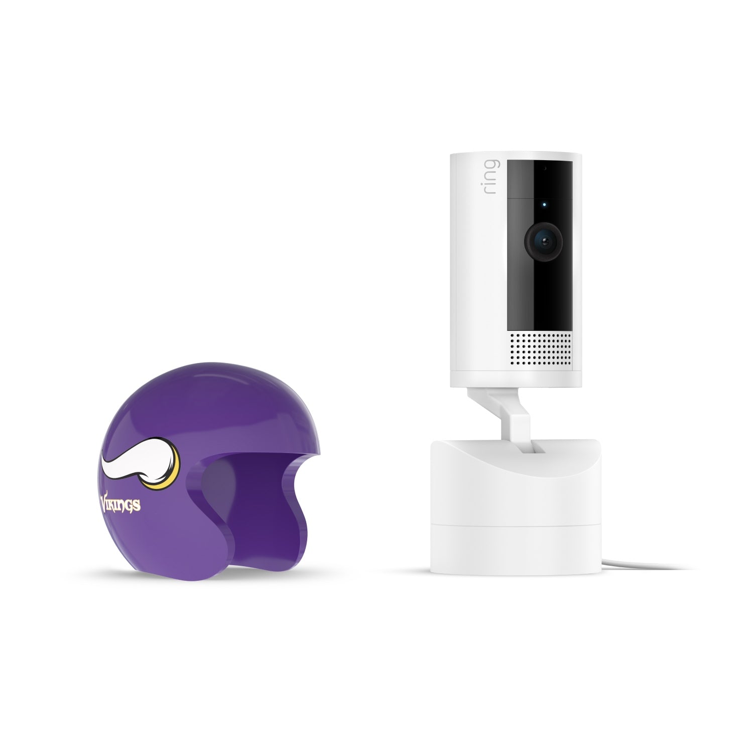 White Ring indoor camera on a stand beside a small purple football helmet with a stylized horn logo, on a white background.